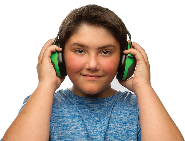 A teenage boy wearing earmuffs used to protect hearing.