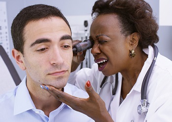 Doctor inspecting patient's ear.