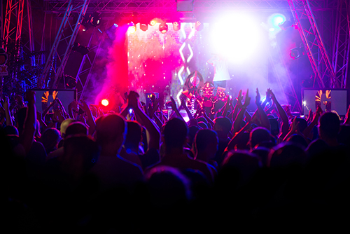 People dancing at an indoor music festival