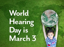 A young girl relaxes outdoors on the grass while holding a large ball that resembles the earth. The image reads: World Hearing Day is March 3.