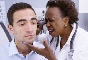 Doctor inspecting patient's ear