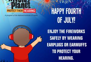 A young boy wears earmuffs to protect his hearing during a fireworks display.