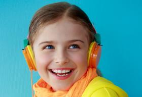 Girl in yellow with headphones on.